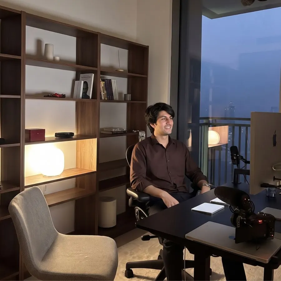 Creator recording at a studio desk with a camera and microphone